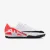 CHUTEIRA NIKE MERCURIAL VAPOR 15 ACADEMY SOCIETY MASCULINA BRANCO/VERMELHO